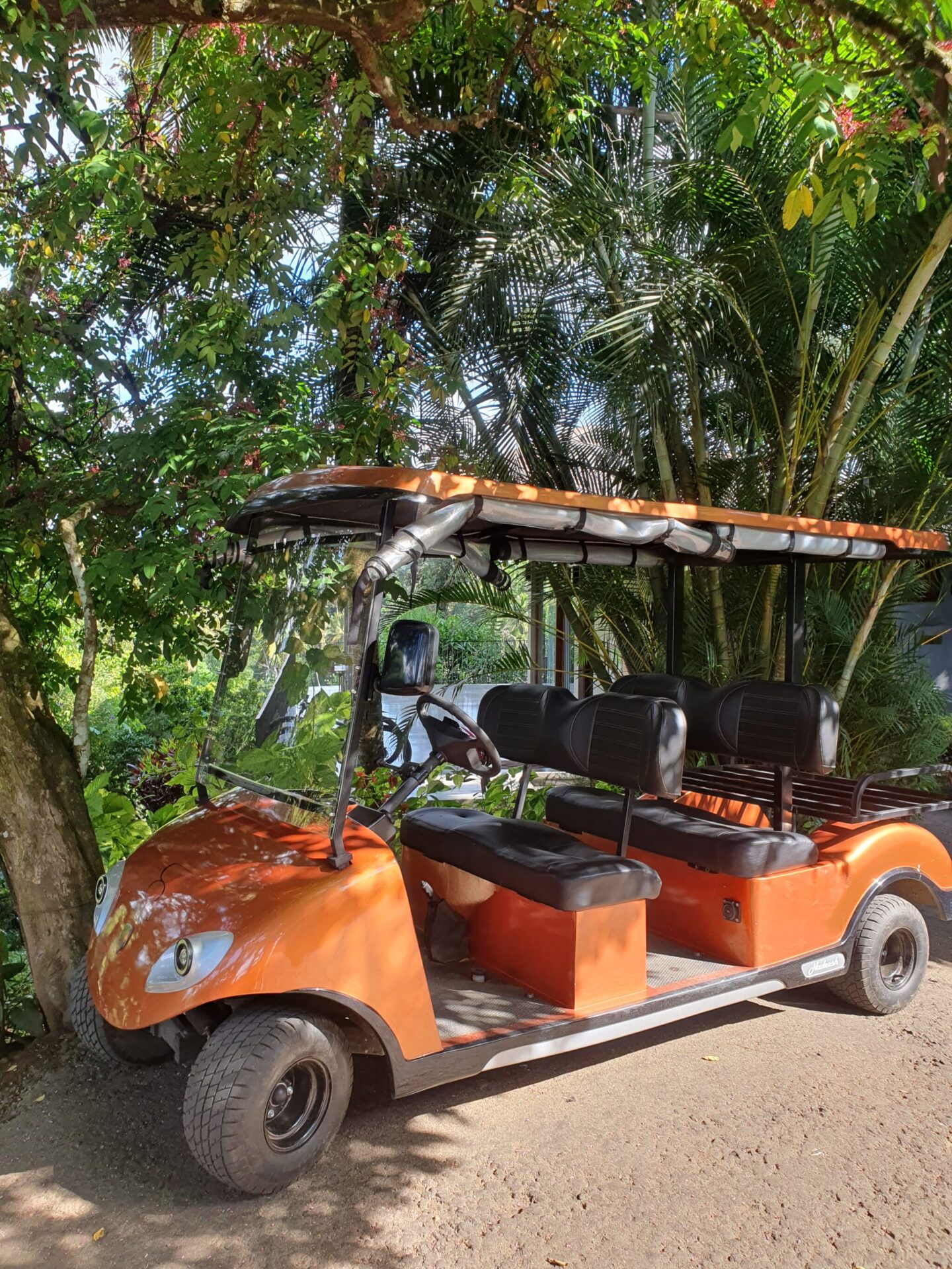 Orange guest transport buggy at Aarunya, used for luggage and villa transfers