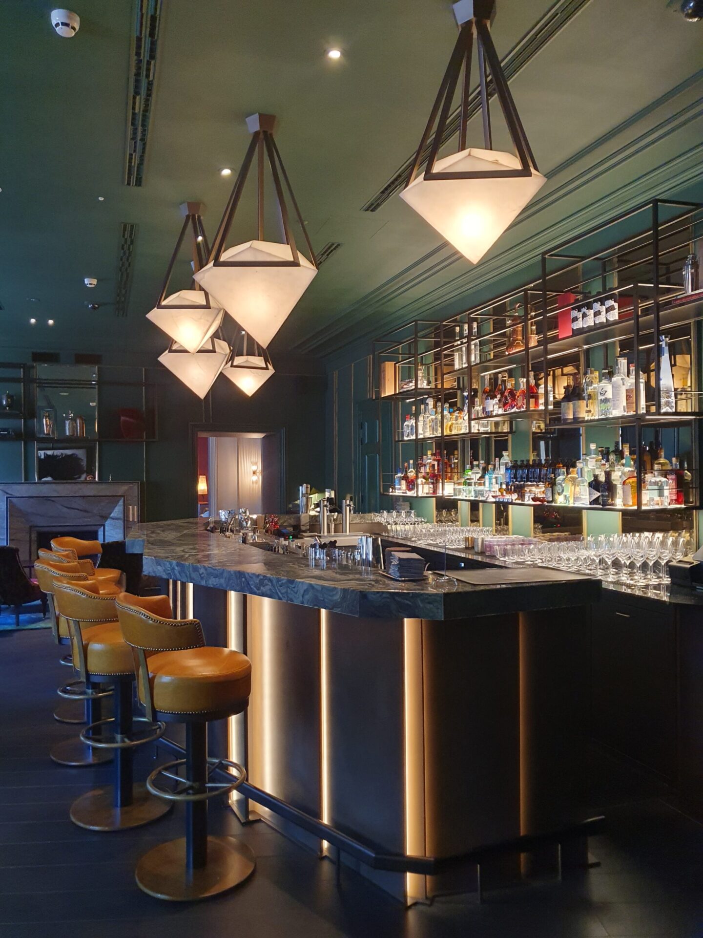 Elegant bar setting with high stools at Bar Advocatuur, Rosewood Amsterdam