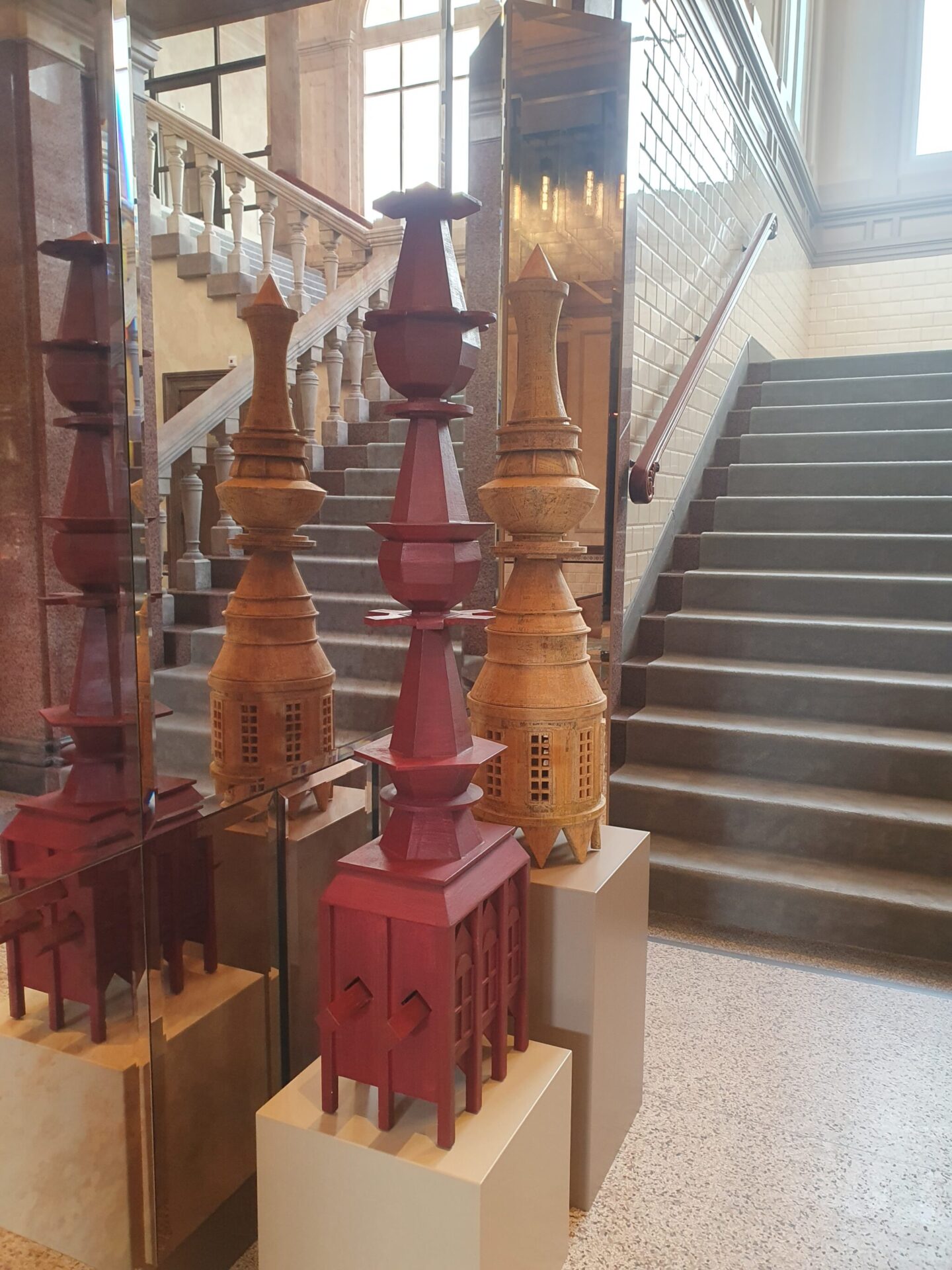 Elegant staircase in the entrance hall of Rosewood Amsterdam with a modern artwork in the foreground
